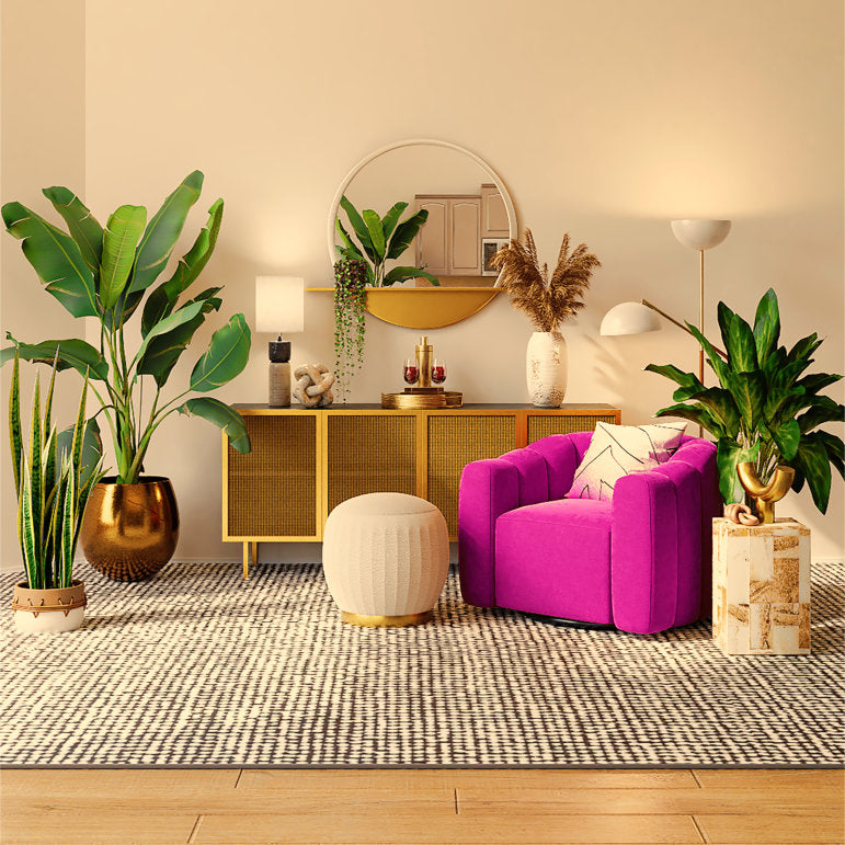 Large artificial indoor plants in a bright room with a deep pink armchair